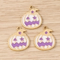Macro detail of three enamel pumpkin charms for DIY Halloween jewelry projects - 10 Pieces Pack / Gold White