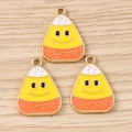 Detailed macro view of three smiling candy corn enamel charms with golden metal loops - Candy Corn Shape / Large, ai-10 Pieces/Pack / Gold