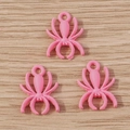 Detailed view of three bright pink spider charms with attachment loops for DIY jewelry - 10 Pieces Pack / Pink