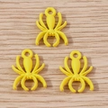 Detailed close-up of three bright yellow spider-shaped alloy pendants for jewelry DIY - 10 Pieces Pack / Yellow
