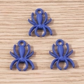 Macro detail of three matte blue spider alloy pendants on a wooden background for DIY jewelry - 10 Pieces Pack / Blue