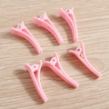 Set of 6 cute pink plastic duckbill hair clips for styling on a wooden background - Pink Duckbill Hair Clips