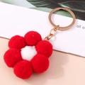 Plüsch Schlüsselanhänger rote Blume mit weißer Mitte und goldenem Ring auf Pfirsich-Tisch - Rot