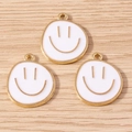 Three cute white enamel smiley face charms with gold trim on light wood background - 10 Pieces Pack / White