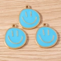 Macro shot of sky blue enamel smiley face charms with gold plating on wood - 10 Pieces Pack / Blue