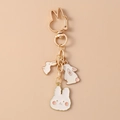 Detail of cute rabbit charms with gold metal clasp and soft pink enamel pendants - Three Rabbits