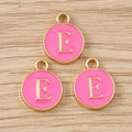 Detailed macro view of pink enamel alphabet letter E round charm with golden alloy rim - Letter E / 10 Pieces Pack