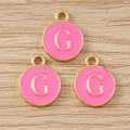 Detailed close-up of three pink enamel round letter G pendants with gold metal frames - Letter G / 10 Pieces Pack