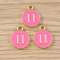 Close-up of pink enamel round charms with golden letter H for DIY jewelry making - Letter H / 10 Pieces Pack