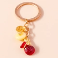 Dettaglio del portachiavi a sacchetto della fortuna rosso con moneta dorata portafortuna - Rosso