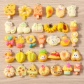 Macro shot of yellow and orange resin DIY pendants in fruit, dessert and animal shapes - 10 Pieces Pack / Yellow