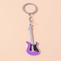 Macro detail of purple electric guitar keychain with intricate silver strings and hardware - Purple