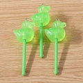 Detail of green glitter resin duck lollipop charms with metal rings on wood background - 10 Pieces Pack / Green