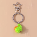 Dettaglio portachiavi a forma di dinosauro verde con moschettone a stella in metallo argento - Stile Stegosauro Verde / Verde