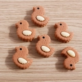 Cute resin cartoon duck sandwich biscuit DIY jewelry pendants on light wood surface - Coffee