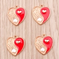 Detailed macro view of heart-shaped Yin Yang charms with red enamel and gold texture - Red