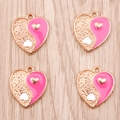 Detail view of heart-shaped Yin Yang charms with pink enamel and gold-plated texture - Pink
