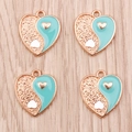 Close-up of four heart-shaped Yin Yang charms in light blue enamel and gold alloy - Blue