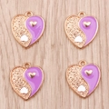 Detailed macro view of heart-shaped Yin Yang pendants in purple enamel and golden alloy finish - Purple