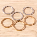 Set of six gold and silver plated flat key rings on light wood background for DIY jewelry - 5 Pieces / Multicolor