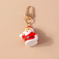 Lindo llavero de Papá Noel de resina con cierre dorado y detalles en color rojo - Papá Noel