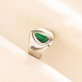 Detail view of a 304 stainless steel ring with a teardrop malachite stone on fabric - Silver Green Stone Style (J524-S-G)