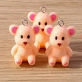 Cute resin bear charms in peach color with metal loop on light wood background - Nude