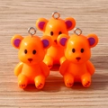 Detail of three resin bear charms in bright orange with purple glitter ears and silver rings - Orange