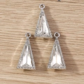 Macro shot of silver triangle crystal pendants with inset rhinestones on wood - 10 Pieces Pack / Silver