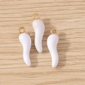 Close-up of three cream-colored horn-shaped resin pendants with gold metal hanging loops - 10 Pieces Pack / White