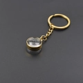 Porte-clés doré avec médaillon en verre convexe de 15mm sur fond sombre - Style Porte-clés Doré (X38-G+PJ28-G)