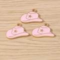 Pink enamel cowboy hat pendants with gold star accents on light wood background - Cowboy Hat with Star Style / 10 Pieces Pack / Pink