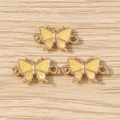 Detailed view of three yellow butterfly enamel connectors for DIY jewelry making - Double-Loop Butterfly Style / 10 Pieces Pack / Yellow