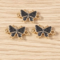 Details von drei schwarzen Emaille-Schmetterlingsanhängern mit Goldösen für DIY-Schmuck - Schwarz