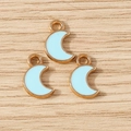 Detailed macro view of three light blue enamel moon pendants with golden metal alloy frames - 30Pcs Pack / Blue