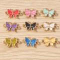 Nine colorful enamel butterfly charms in gold alloy for DIY jewelry making and necklaces - Double-Loop Butterfly Style / 10 Pieces Pack / Multicolor