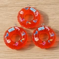 Detailed macro view of orange resin lifebuoy charms with embedded dolphin motifs - 5 Pieces / Red