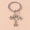 Detail shot of silver metal star keychains with inset sparkling round crystals - Silver