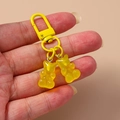 Detailed macro of translucent yellow gummy bear charms with matching spring hook - Pure Yellow Style / Yellow