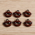 Macro shot of Halloween vampire lip pendants with red enamel and white fangs - 10 Pieces Pack / Lip