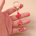 Portachiavi a farfalla dorato con ciondoli in smalto rosa per decorazione zaino - Rosso