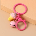 Detailed view of pink ice cream cone keychain with matching metal bell and painted hardware - Pink