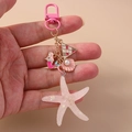 Portachiavi rosa tema oceano con ciondoli sirena stella e conchiglia su catena oro - Stella Marina Rosa