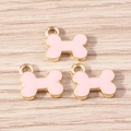 Set of bone-shaped alloy pendants with pink enamel and gold plating for DIY jewelry - 10 Pieces Pack / Pink