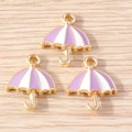 Detail of three purple and white striped umbrella pendants with gold-plated metal frames - Purple