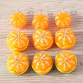 Macro detail of resin orange segment charms with silver metal rings on wood background - Mixed Style (YD1615hunkuan)