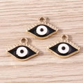 Detailed view of three golden evil eye charms with black and white enamel for DIY jewelry - Black (YD1675heise)