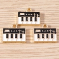Detailed close-up of retro enamel piano charms for DIY jewelry on wooden surface - 10 Pieces Pack / Black