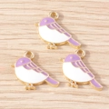 Detailed macro of three purple and white enamel bird charms with gold metal edges - Bird Charm (YD1719) / 10 Pieces Pack / Purple