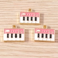 Detailed macro shot of vintage piano charms with pink enamel and gold-plated edges - 10 Pieces Pack / Pink